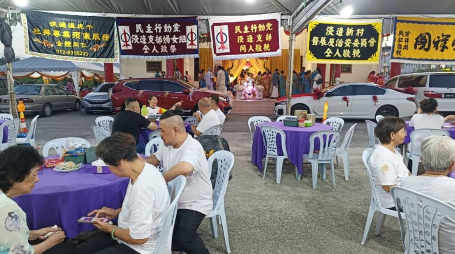 A wedding celebration and funeral wake happening opposite each other.
