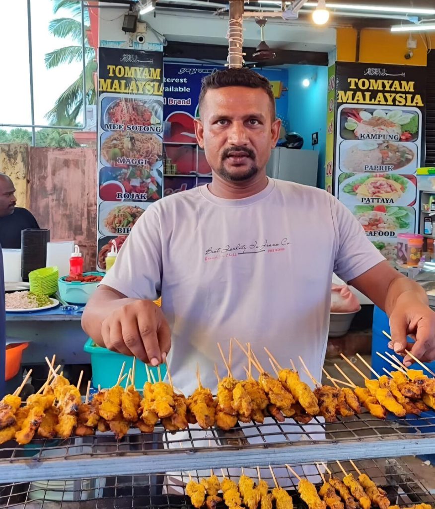 Kani Boy was doing chicken satay in his restaurant