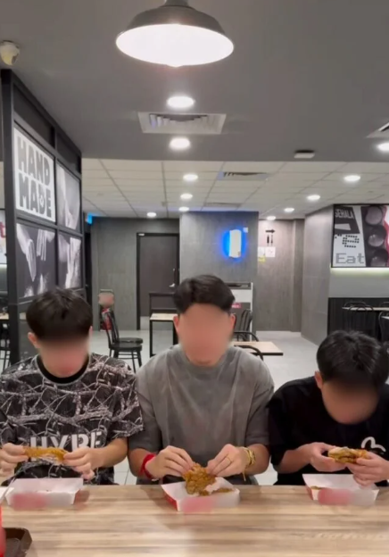 Content creators eating chicken at a fast food joint. 
