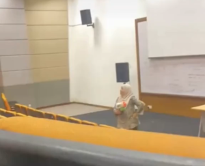 Madam Amie playfully pointing a water gun during lecture