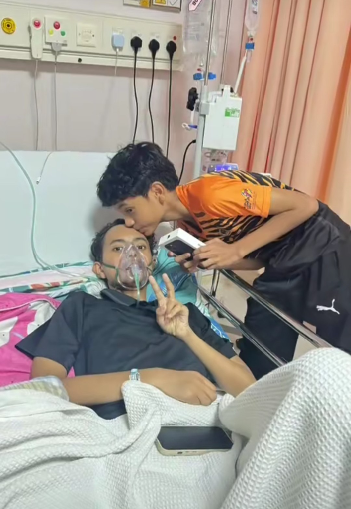 Screenshot from the video shows Aidil was kissing his brother's forehead