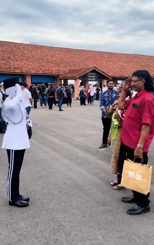 Screenshot from the video shows the inspector was giving a salute to her parents