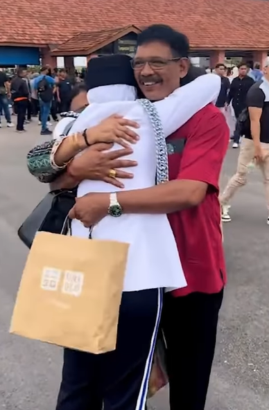 Screenshot from the video shows that the daughter was hugging her parents