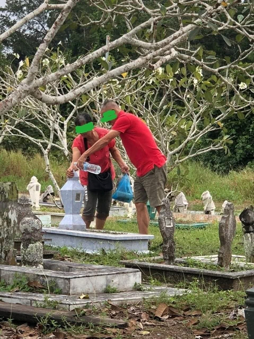 A Chinese couple visiting their son’s gravesite with love