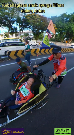 Screenshot from the video shows that a father pushing his daughter in wheelchair at KLSCM 2025