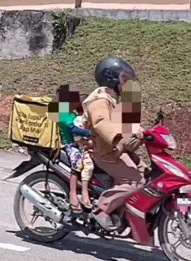 The mother was riding motorcycle while carried her three kids