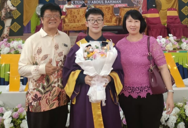 Lim and his wife during their son's graduation ceremony