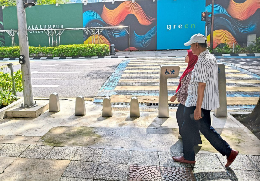 Motorcycle access blocked by bollards on Jalan Raja Laut pavement