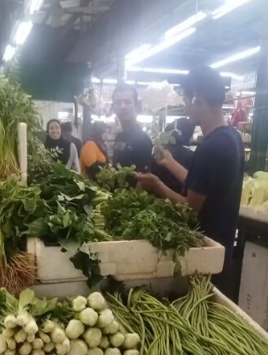 The father was buying food at the market