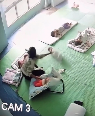 Screenshot shows the baby being rolled by the caregiver