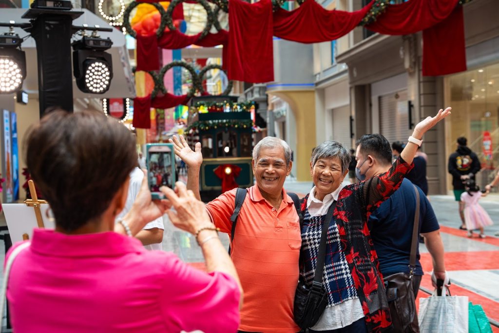 Visitors posing with the festive decorations and the Tram on High Street