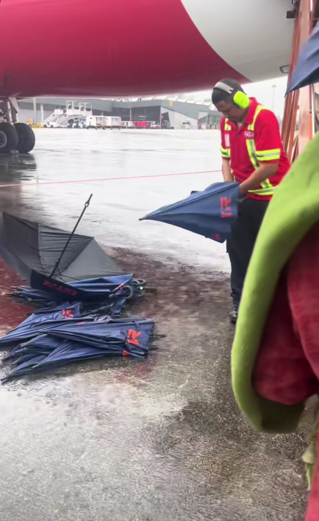 They assisted families with bags, ensuring they stayed dry on the way to board