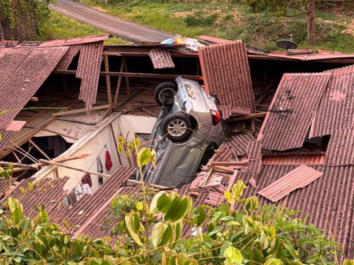Vehicle skids off road and crashes into house roof in Kuala Pilah, two injured